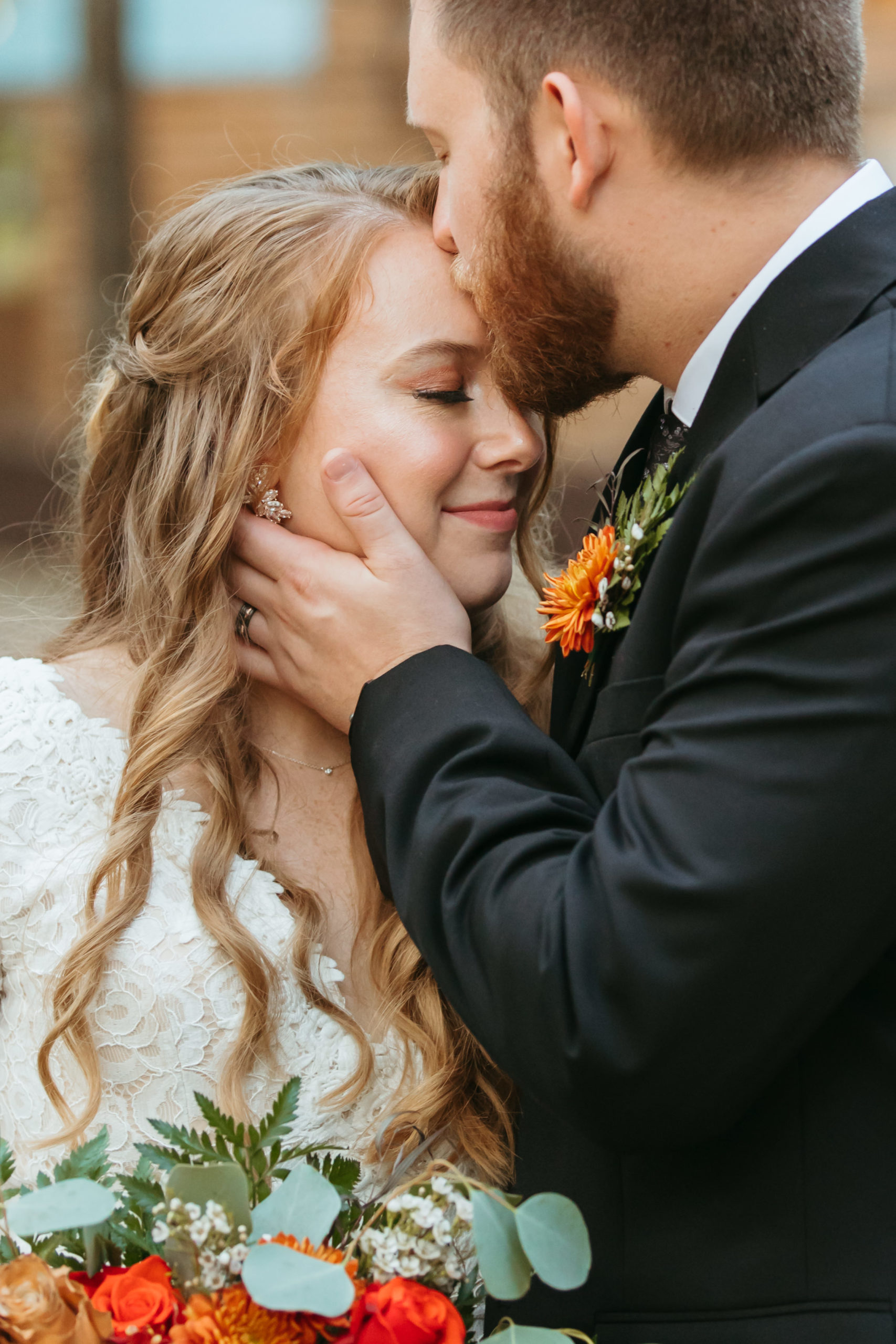 Wedding couple in gentle hug during intimate fall wedding in Eureka Springs, Arkansas.