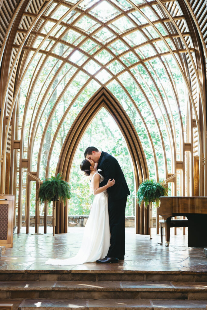 Elopement couple at the altar of the Mildred B. Cooper Memorial Chapel in Bella Vista, Arkansas